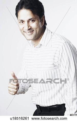 Portrait of a businessman showing a thumbs up sign View Large Photo Image Stock Image - Portrait of a businessman showing a thumbs up sign. Fotosearch