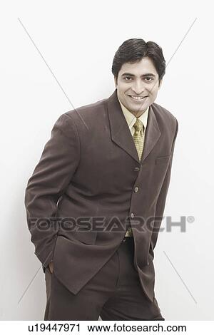 Portrait of a businessman standing with his hands in his pockets View Large Photo Image Stock Image - Portrait of a businessman standing with his hands in his pockets. Fotosearch