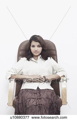Stock Photo - Portrait of a businesswoman sitting on an office chair. Fotosearch