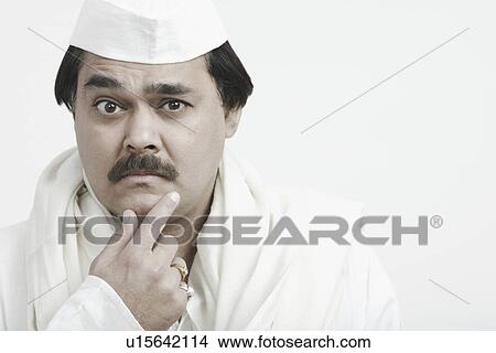 Portrait of a mature man touching his face View Large Photo Image Picture - Portrait of a mature man touching his face. Fotosearch