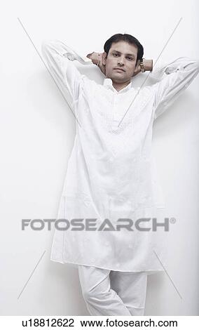 Stock Image - Portrait of a mid adult man standing with his hands behind his head. Fotosearch