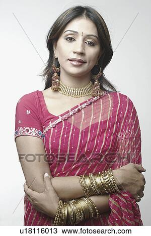 Portrait of a mid adult woman standing with her arms crossed View Large Photo Image Stock Image - Portrait of a mid adult woman standing with her arms crossed. Fotosearch