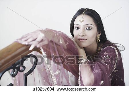 Portrait of a teenage girl leaning over a railing View Large Photo Image Picture - Portrait of a teenage girl leaning over a railing. Fotosearch