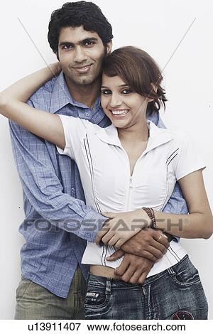 Portrait of a young man embracing a young woman View Large Photo Image Stock Photo - Portrait of a young man embracing a young woman. Fotosearch