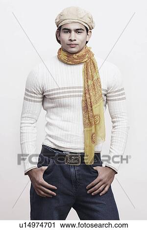 Portrait of a young man standing with his hands in his pockets View Large Photo Image Stock Image - Portrait of a young man standing with his hands in his pockets. Fotosearch