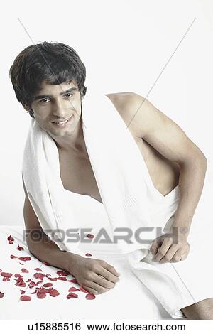 Stock Photograph - Portrait of a young man with a towel around his neck. Fotosearch