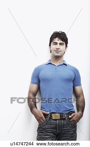 Picture - Portrait of a young man with his hands in his pocket. Fotosearch
