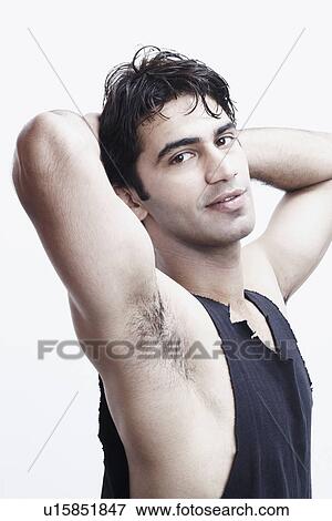 Portrait of a young man with his hands behind his head View Large Photo Image Stock Photo - Portrait of a young man with his hands behind his head. Fotosearch