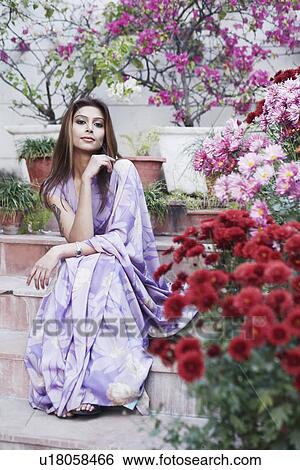 Portrait of a young woman sitting on steps View Large Photo Image Stock Photograph - Portrait of a young woman sitting on steps. Fotosearch
