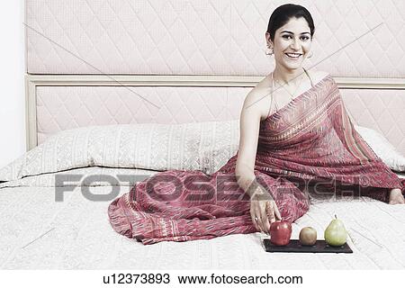 Portrait of a young woman smiling View Large Photo Image Stock Image - Portrait of a young woman smiling. Fotosearch