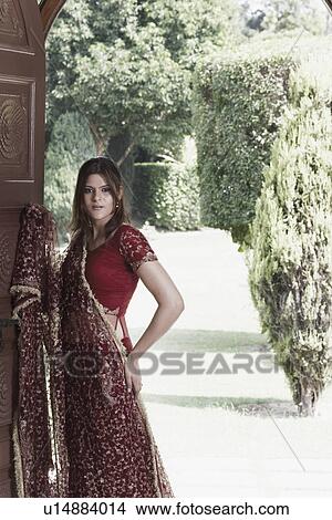Picture - Portrait of a young woman standing. Fotosearch