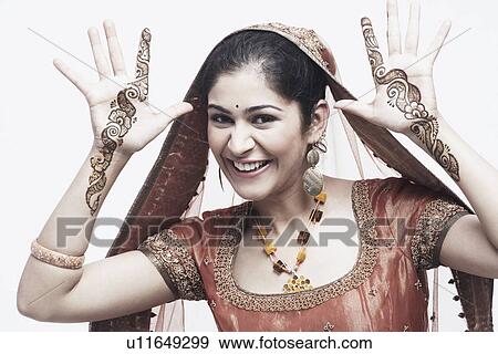 Stock Photo - Portrait of a young woman with henna tattoo's on her hands. Fotosearch