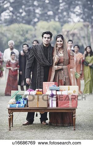 Stock Photo - Gifts on the table in front of a newlywed couple. Fotosearch