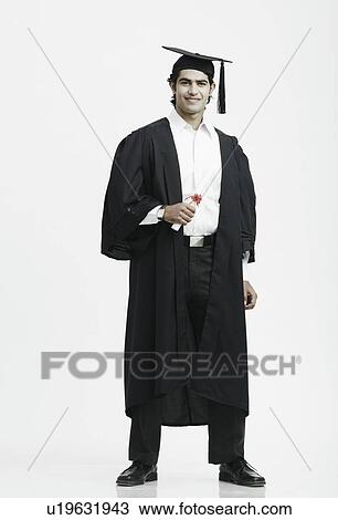 Stock Image - Portrait of a male graduate holding a diploma. Fotosearch