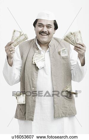 Portrait of a mature man holding Indian currency View Large Photo Image Stock Photo - Portrait of a mature man holding Indian currency. Fotosearch