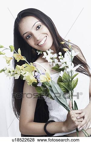 Stock Photo - Portrait of a teenage girl holding a bunch of flowers. Fotosearch