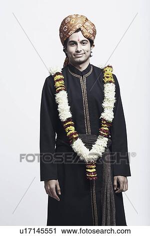 Portrait of a young man wearing a traditional wedding outfit View Large Photo Image Stock Image - Portrait of a young man wearing a traditional wedding outfit. Fotosearch