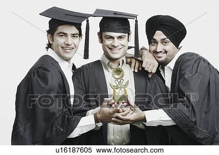 Portrait of three male graduates holding a trophy View Large Photo Image Stock Photography - Portrait of three male graduates holding a trophy. Fotosearch