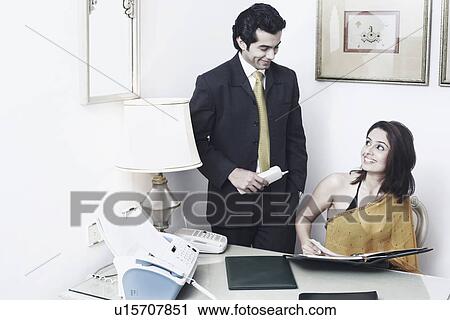 Businessman and a businesswoman in an office View Large Photo Image Stock Image - Businessman and a businesswoman in an office. Fotosearch
