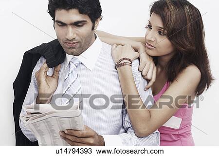 Businessman standing with a young woman leaning on him View Large Photo Image Stock Image - Businessman standing with a young woman leaning on him. Fotosearch