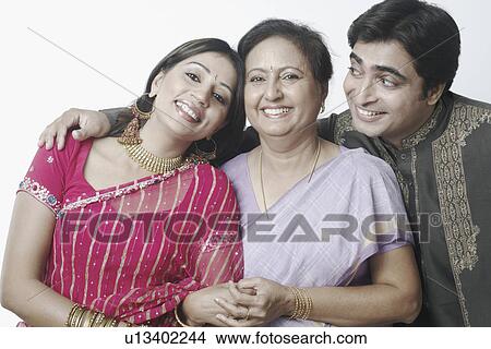 Close-up of a mid adult couple and a mature woman smiling View Large Photo Image Picture - Close-up of a mid adult couple and a mature woman smiling. Fotosearch