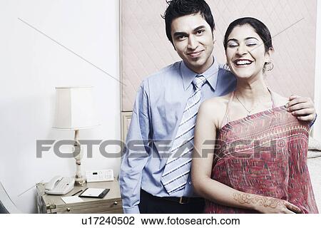 Close-up of a young couple smiling View Large Photo Image Stock Image - Close-up of a young couple smiling. Fotosearch