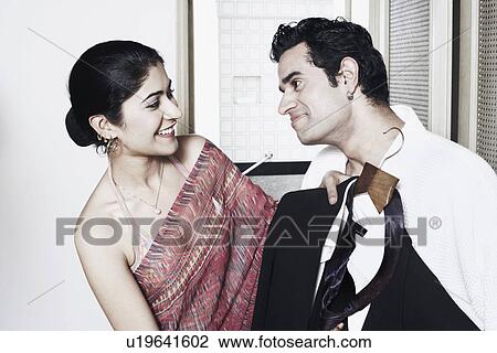 Close-up of a young couple smiling View Large Photo Image Stock Image - Close-up of a young couple smiling. Fotosearch