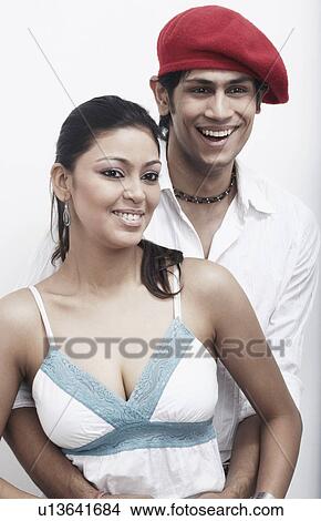 Close-up of a young man embracing a young woman from behind View Large Photo Image Picture - Close-up of a young man embracing a young woman from behind. Fotosearch