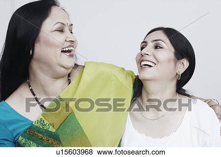 Stock Photo - Close-up of two mature women holding each other. Fotosearch