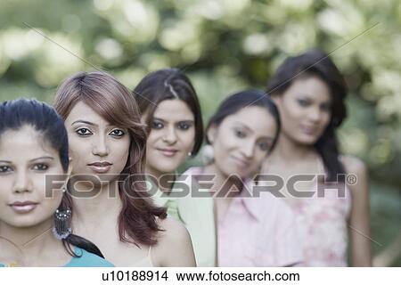 Five women standing in a row View Large Photo Image Picture - Five women standing in a row. Fotosearch