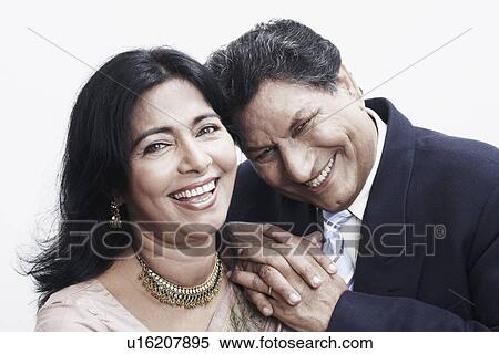 Stock Photography - Portrait of a senior man resting his hands on the shoulder of a mature woman. Fotosearch