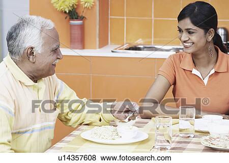Close-up of a father sitting at the table with his daughter View Large Photo Image Stock Photo - Close-up of a father sitting at the table with his daughter. Fotosearch
