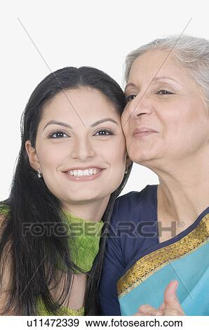 Stock Photo - Close-up of a mother and her daughter smiling. Fotosearch