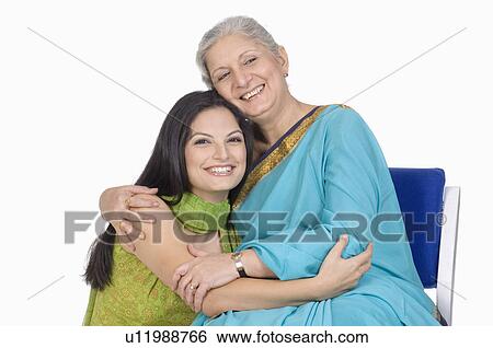 Close-up of a mother hugging her daughter View Large Photo Image Stock Photograph - Close-up of a mother hugging her daughter. Fotosearch