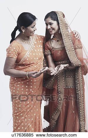 Mother and her daughter looking at each other View Large Photo Image Stock Photography - Mother and her daughter looking at each other. Fotosearch