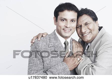 Stock Image - Portrait of a father and his son smiling. Fotosearch