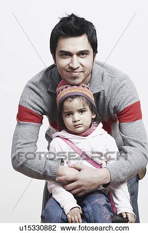 Stock Image - Portrait of a father hugging his daughter. Fotosearch