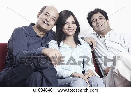Stock Image - Portrait of a father sitting with his son and his daughter. Fotosearch