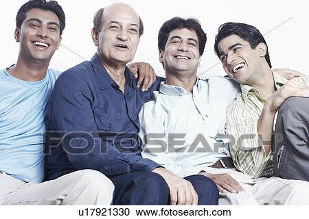 Portrait of a father sitting with his three sons View Large Photo Image Stock Image - Portrait of a father sitting with his three sons. Fotosearch