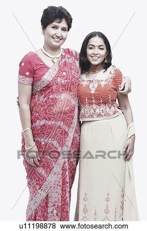 Stock Photo - Portrait of a mother standing with her daughter. Fotosearch