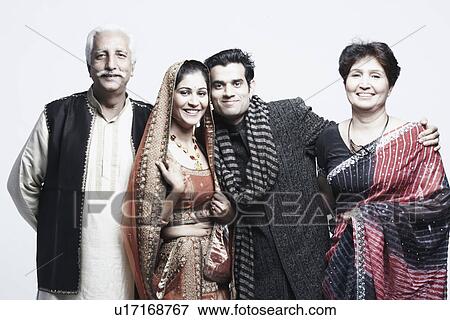 Portrait of a newlywed couple with their parents View Large Photo Image Stock Photo - Portrait of a newlywed couple with their parents. Fotosearch