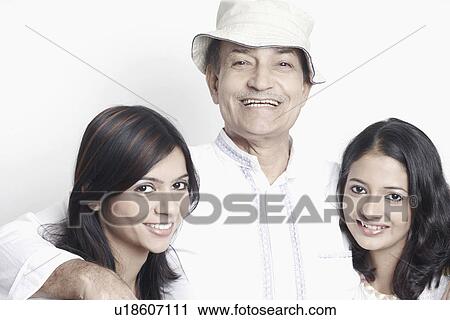Portrait of a senior man with two young women View Large Photo Image Stock Image - Portrait of a senior man with two young women. Fotosearch