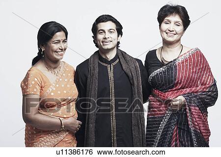Stock Photograph - Portrait of a young man and two mature women smiling. Fotosearch