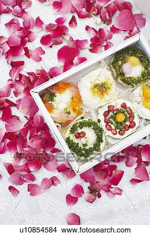Close-up of a box of Indian sweets with flower petals around it View Large Photo Image Picture - Close-up of a box of Indian sweets with flower petals around it. Fotosearch
