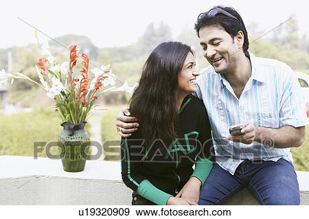 Close-up of a young couple laughing View Large Photo Image Stock Photo - Close-up of a young couple laughing. Fotosearch