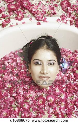 High angle view of a young woman lying in a bathtub covered with flower petals View Large Photo Image Stock Photography - High angle view of a young woman lying in a bathtub covered with flower petals. Fotosearch