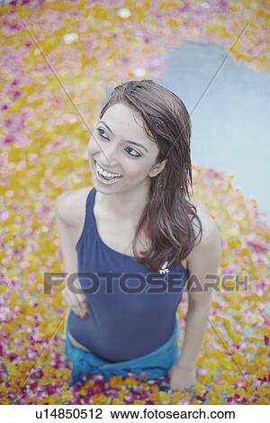 High angle view of a young woman standing in a swimming pool filled with flower petals View Large Photo Image Stock Image - High angle view of a young woman standing in a swimming pool filled with flower petals. Fotosearch