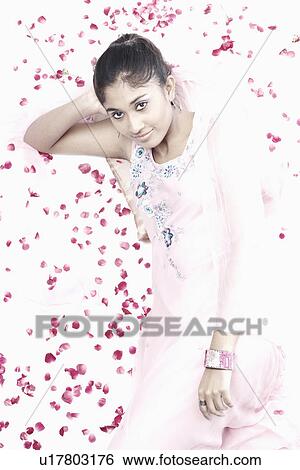 Stock Photograph - High angle view of a young woman resting her head on her hand. Fotosearch