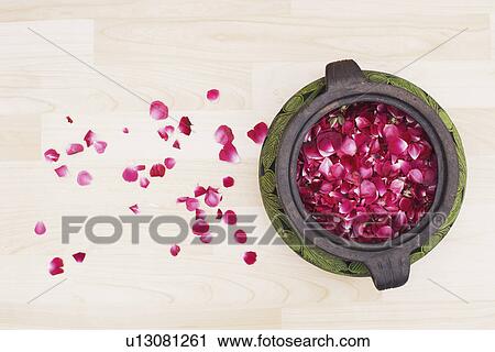 Stock Image - High angle view of rose petals in a pot. Fotosearch