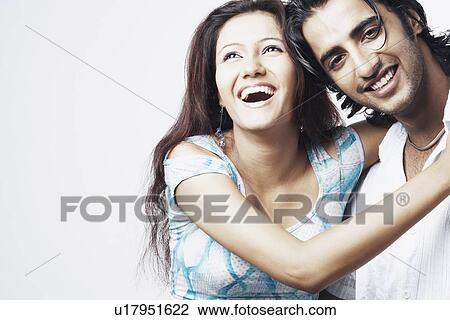 Close-up of a young couple smiling View Large Photo Image Stock Image - Close-up of a young couple smiling. Fotosearch